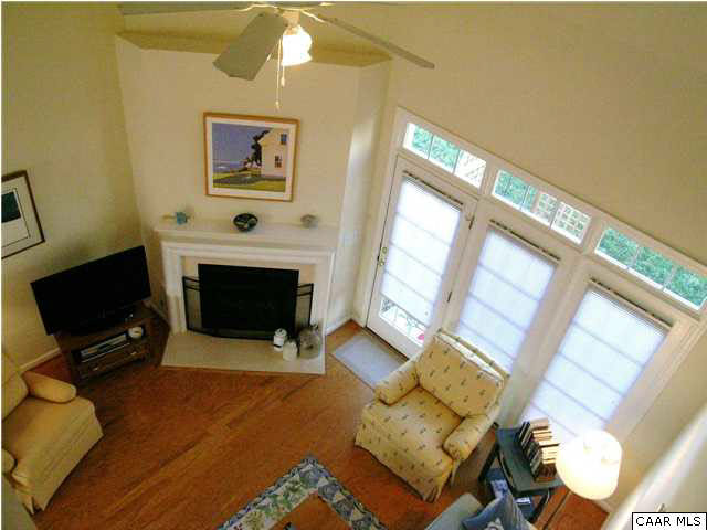 1310 Stoney Ridge Road Charlottesville, VA 22902 - Photo 4 of 22 a living room with furniture a fireplace and a flat screen tv