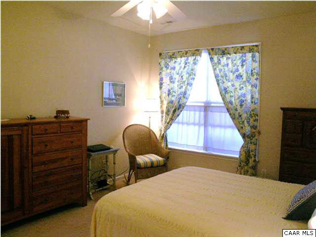 1310 Stoney Ridge Road Charlottesville, VA 22902 - Photo 5 of 22 a bedroom with a bed and a chandelier