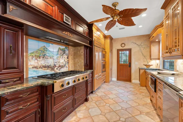 a kitchen with stainless steel appliances granite countertop a stove and a refrigerator