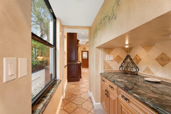 a kitchen with granite countertop a stove and a refrigerator