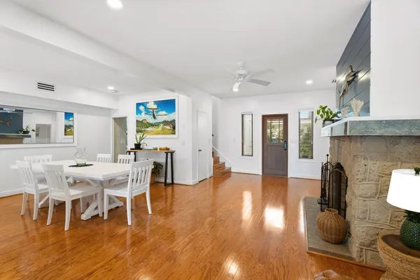 a living room with furniture a fireplace and wooden floor