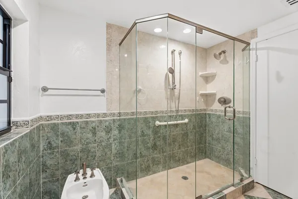 a bathroom with a shower and a sink