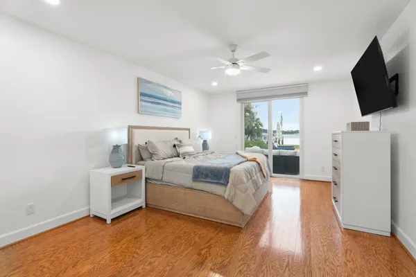 a spacious bedroom with a bed and a flat screen tv