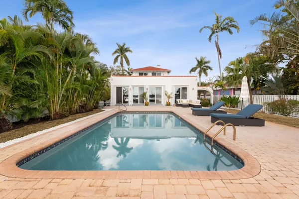 a view of swimming pool with chairs