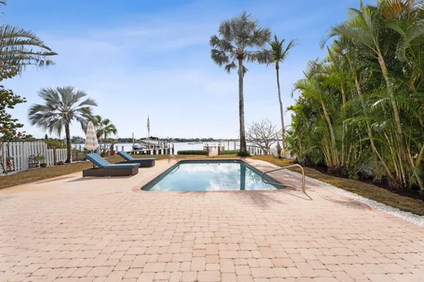 a view of swimming pool with a table and chairs