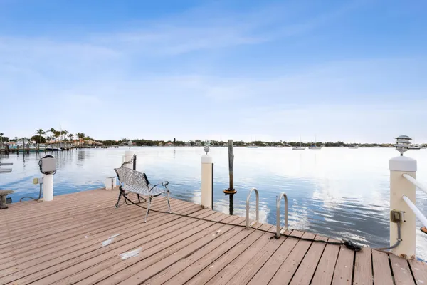a view of a lake with boats and trees in the background