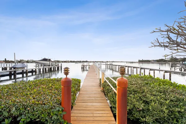 a balcony with wooden floor and lake view