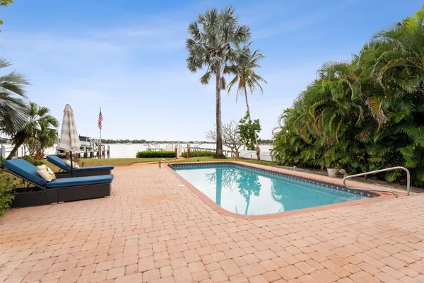 a view of swimming pool with chairs