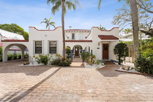 a front view of a house with garden and patio