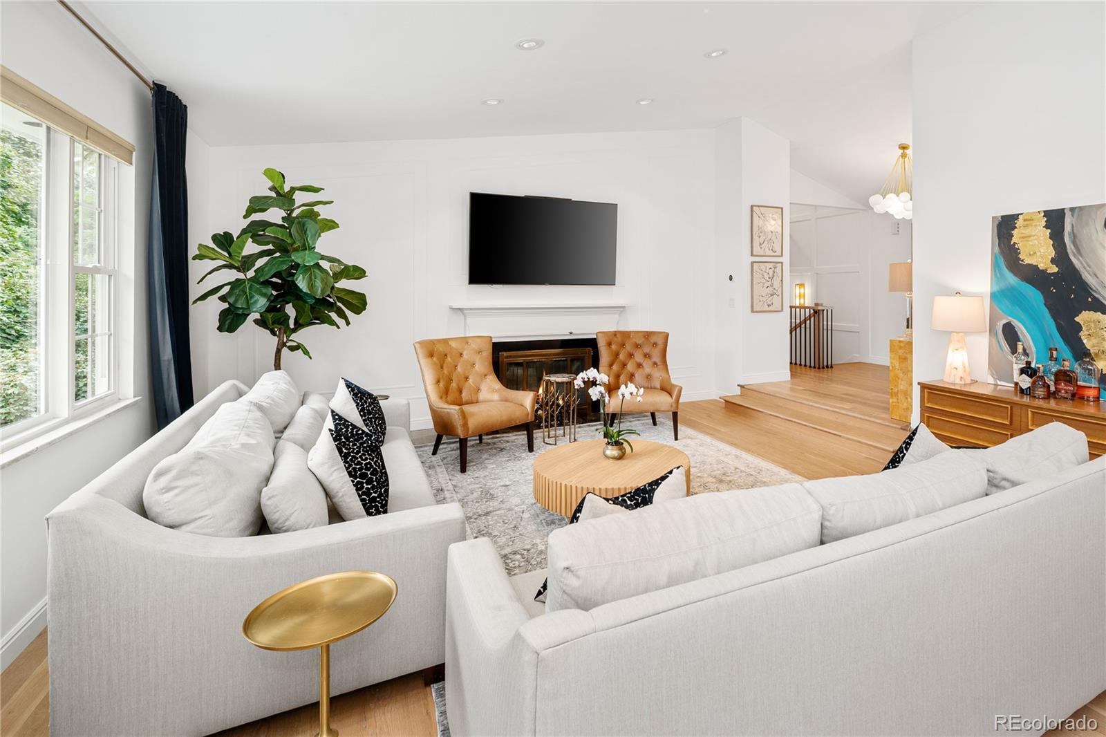 1 Hillside Drive Wheat Ridge, CO 80215 - Photo 12 of 50 a living room with furniture and a flat screen tv