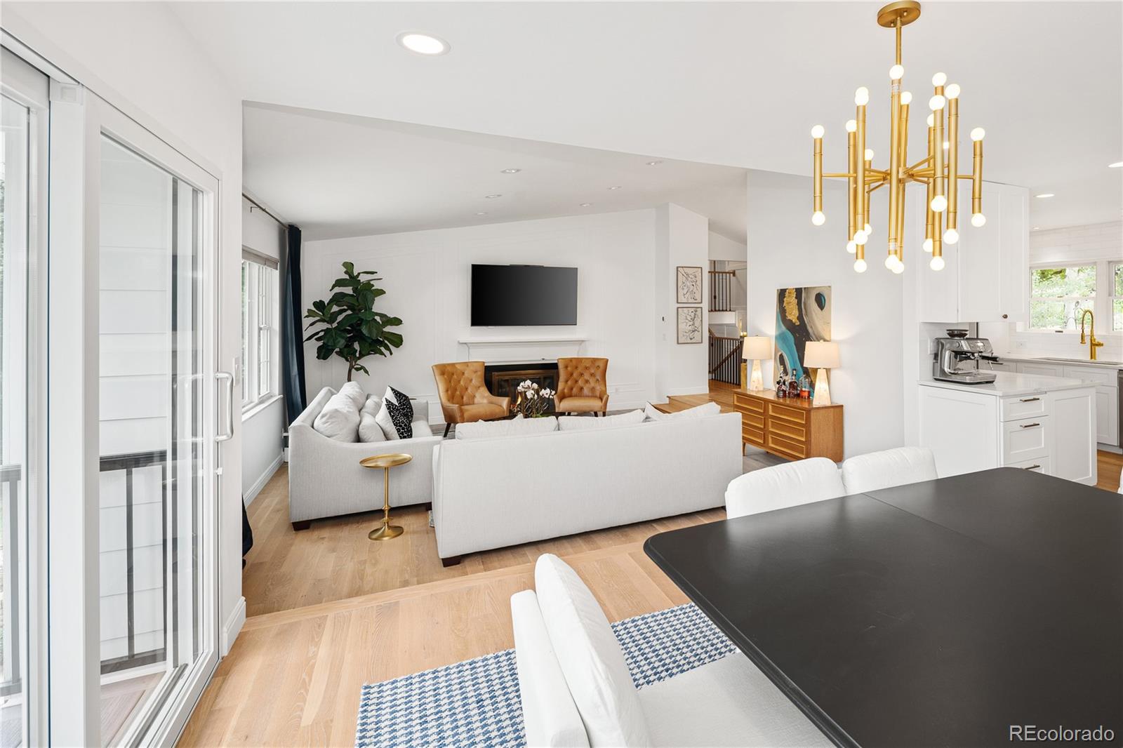 1 Hillside Drive Wheat Ridge, CO 80215 - Photo 16 of 50 a living room with furniture and a flat screen tv