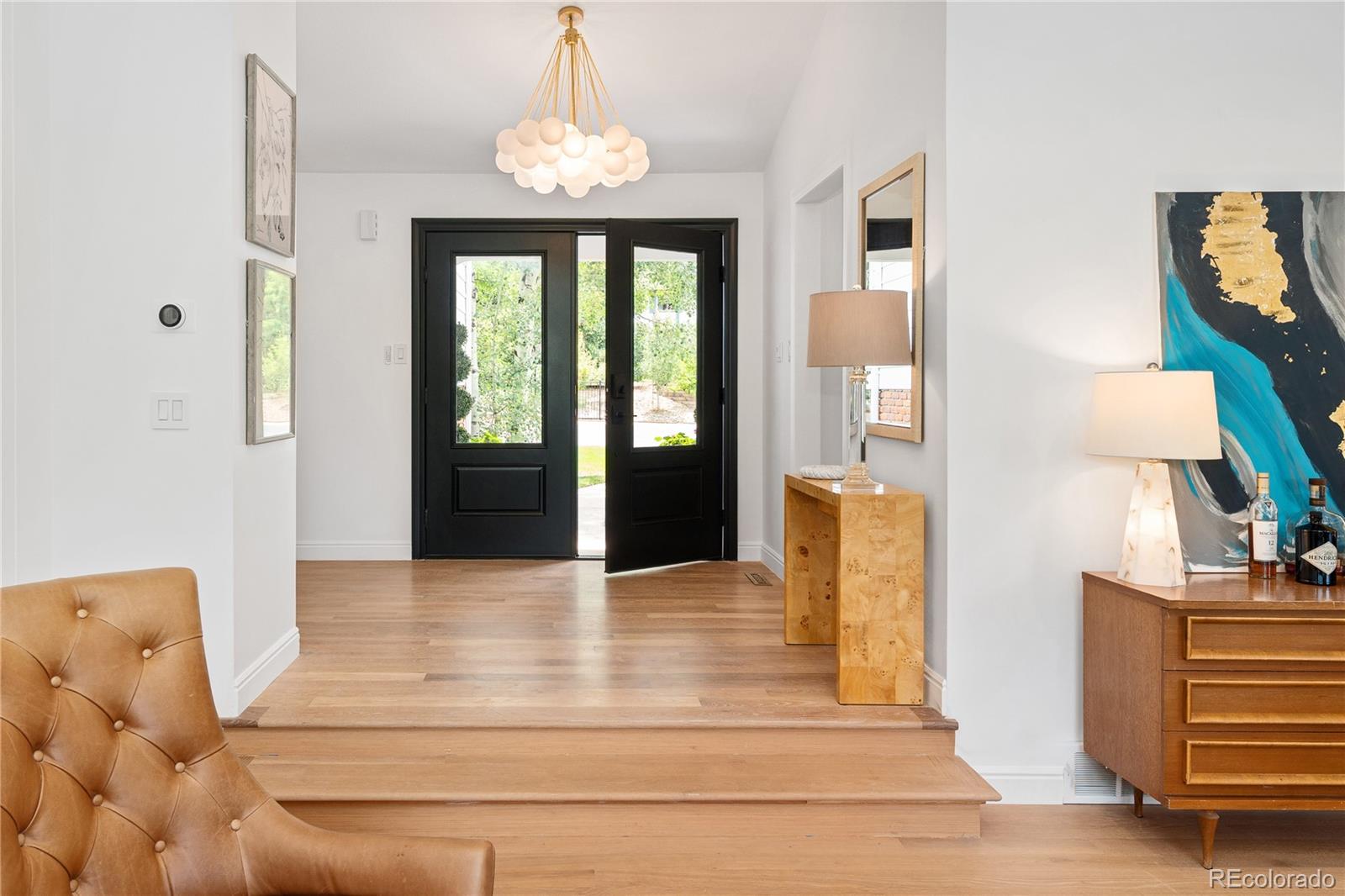 1 Hillside Drive Wheat Ridge, CO 80215 - Photo 2 of 50 a living room with furniture and a chandelier