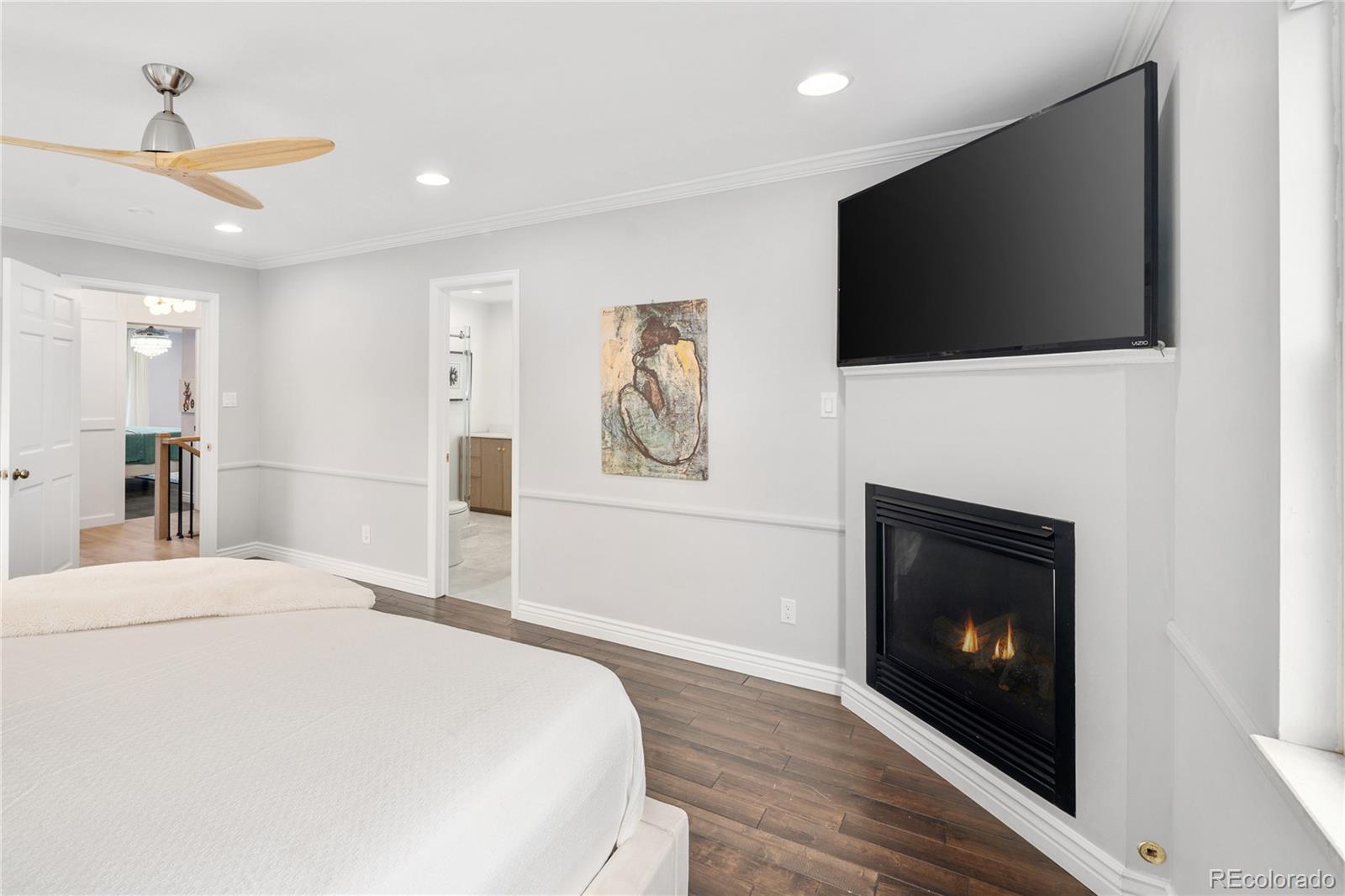 1 Hillside Drive Wheat Ridge, CO 80215 - Photo 27 of 50 a bedroom with a bed and a flat screen tv