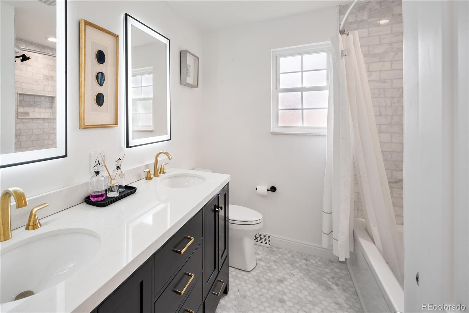1 Hillside Drive Wheat Ridge, CO 80215 - Photo 31 of 50 a bathroom with a sink and a mirror