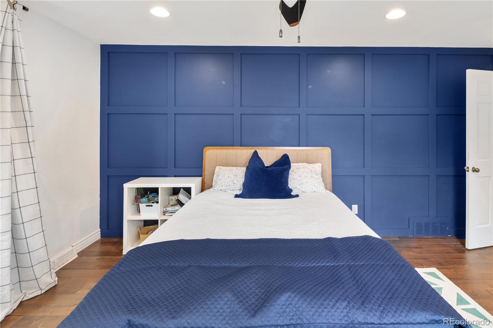 1 Hillside Drive Wheat Ridge, CO 80215 - Photo 32 of 50 a large bed sitting in a bedroom next to a bathroom