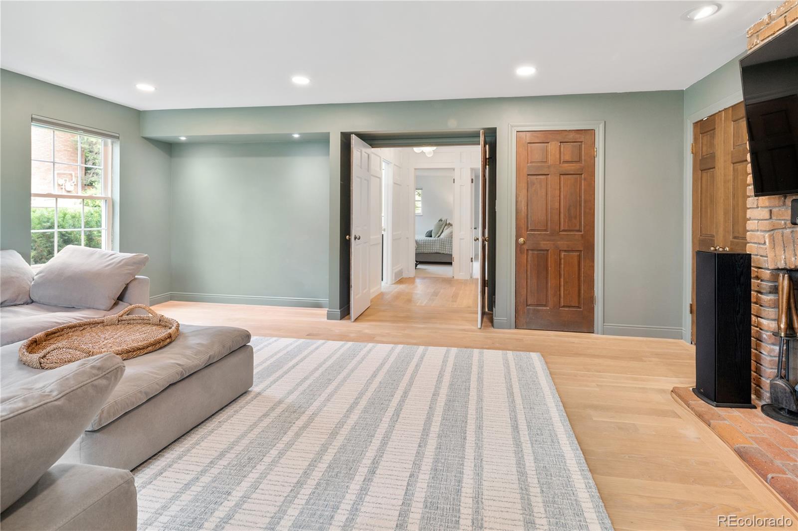 1 Hillside Drive Wheat Ridge, CO 80215 - Photo 37 of 50 a spacious bedroom with a large bed and a flat screen tv