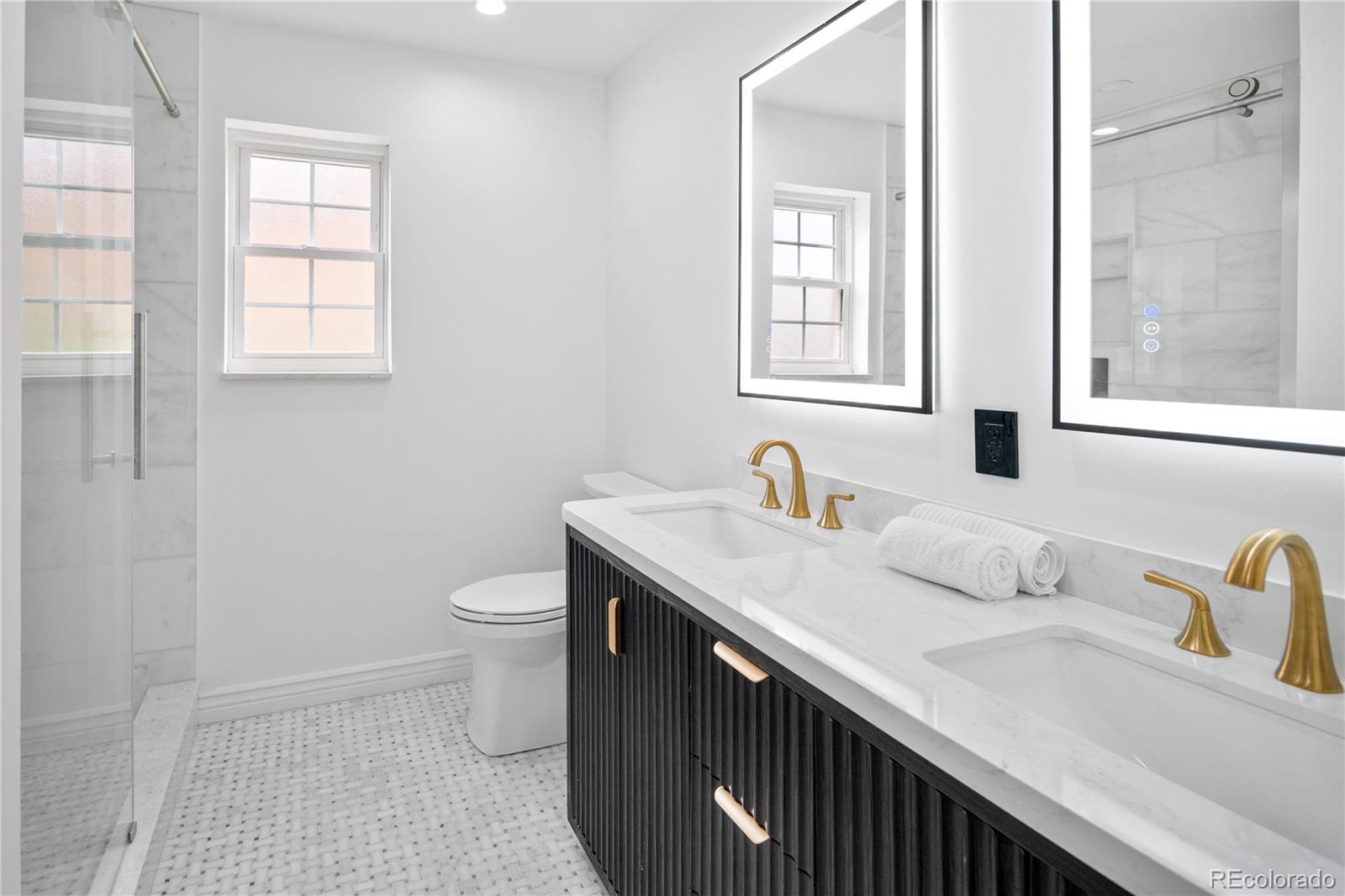 1 Hillside Drive Wheat Ridge, CO 80215 - Photo 38 of 50 a bathroom with a granite countertop sink a toilet and a window