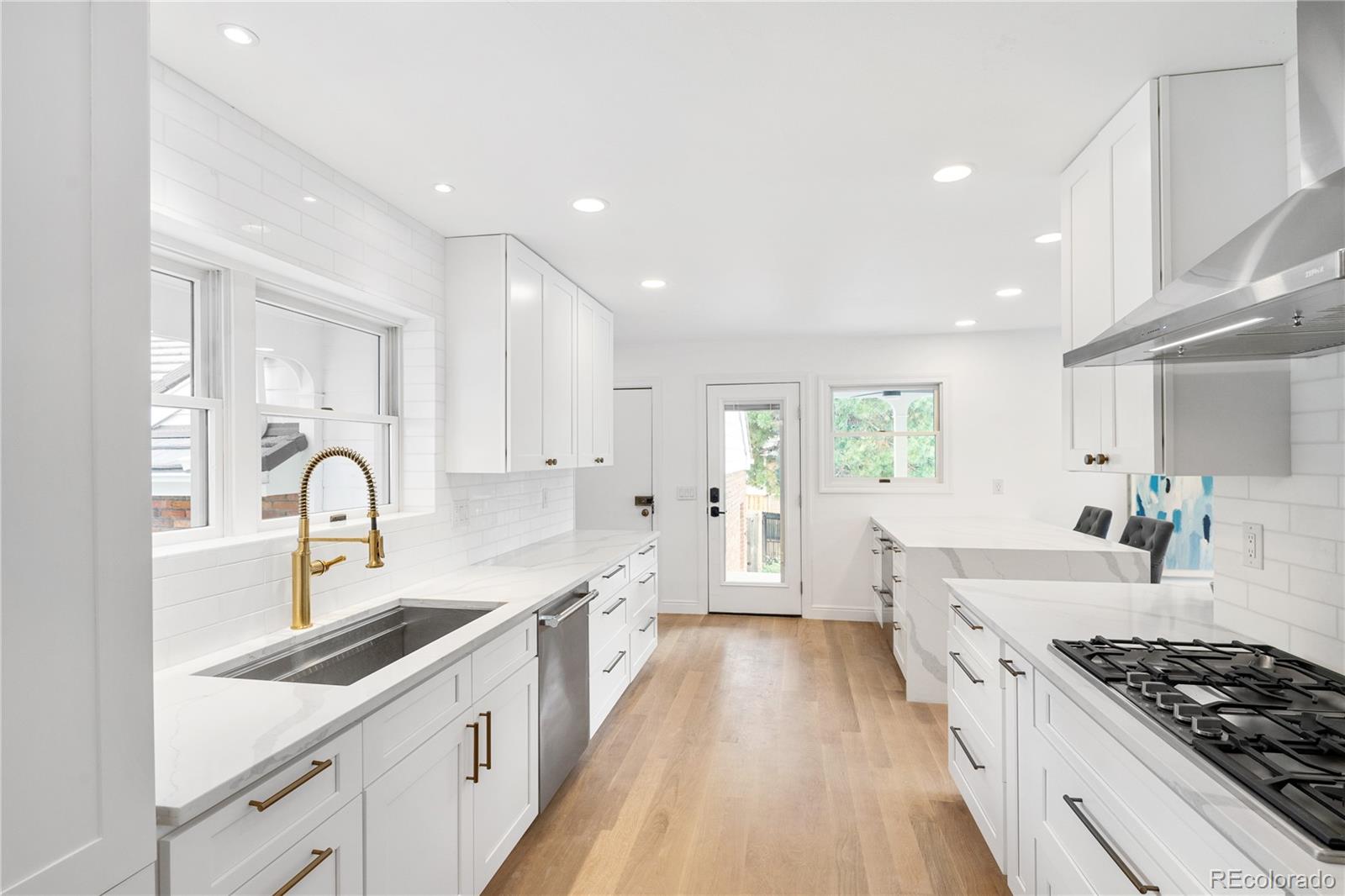 1 Hillside Drive Wheat Ridge, CO 80215 - Photo 4 of 50 a large kitchen with stainless steel appliances granite countertop a sink and cabinets