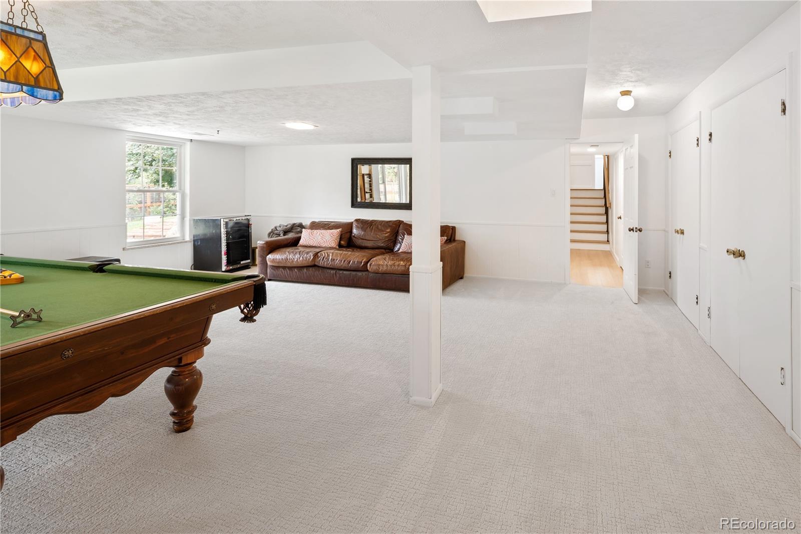 1 Hillside Drive Wheat Ridge, CO 80215 - Photo 41 of 50 a living room with furniture and a wooden floor