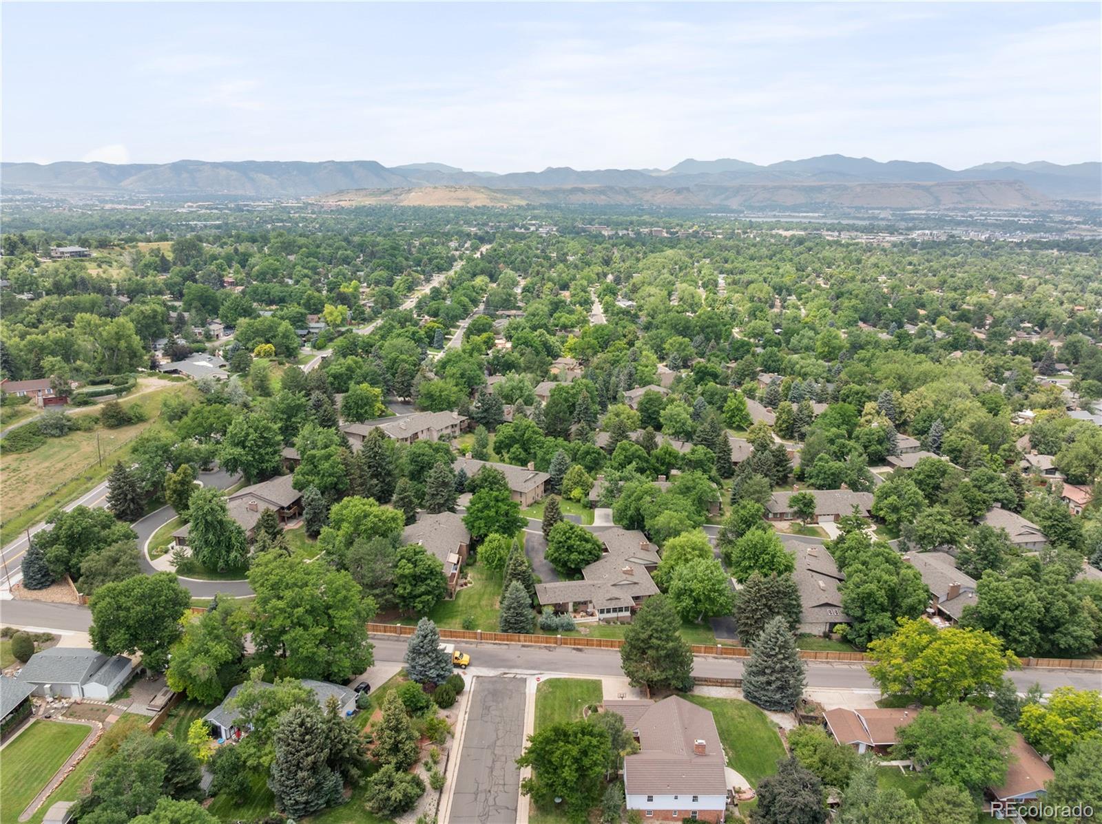 1 Hillside Drive Wheat Ridge, CO 80215 - Photo 47 of 50 an aerial view of green landscape with trees houses and mountain view