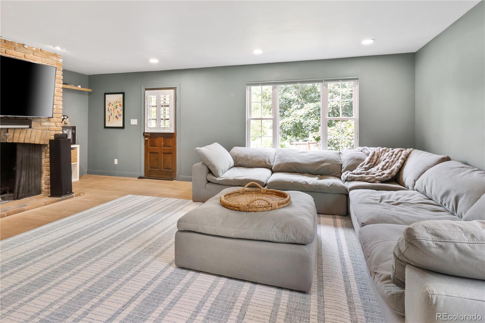 1 Hillside Drive Wheat Ridge, CO 80215 - Photo 8 of 50 a living room with furniture and a flat screen tv
