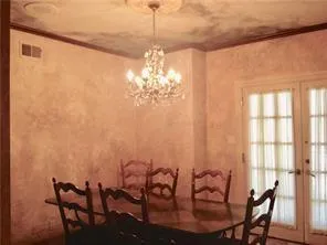 a view of a dining room with furniture and chandelier