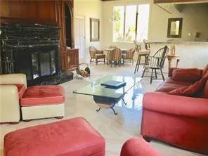 a living room with furniture a large window and a table