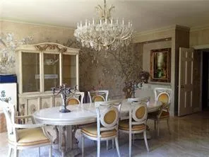 a view of a dining room with furniture and chandelier