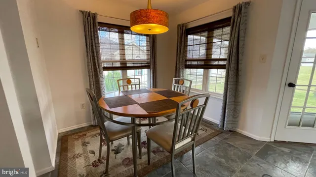 a view of a dining room with furniture and window