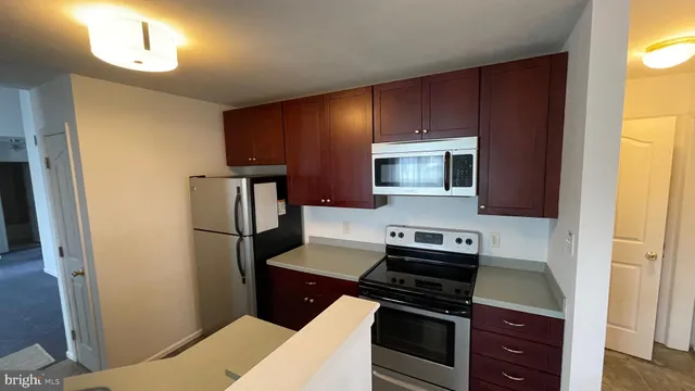 a kitchen with a refrigerator stove and microwave