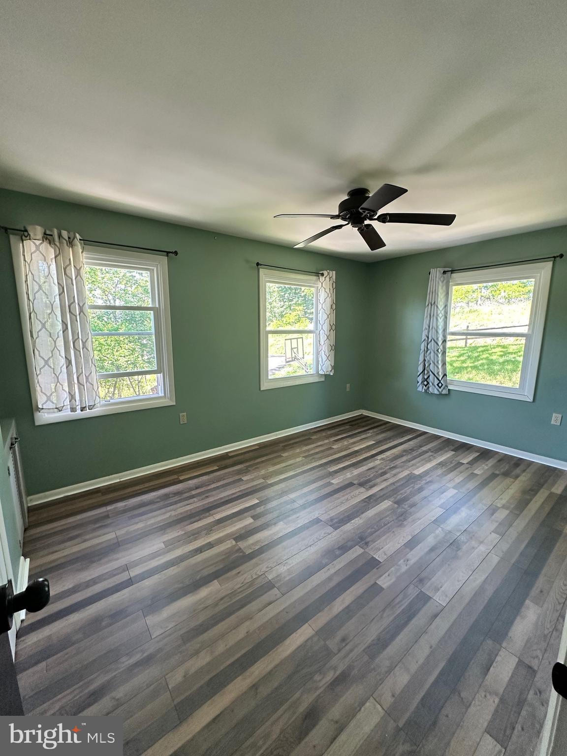 1801 Crums Mill Road Harrisburg, PA 17110 - Photo 12 of 29 a view of an empty room with window and wooden floor