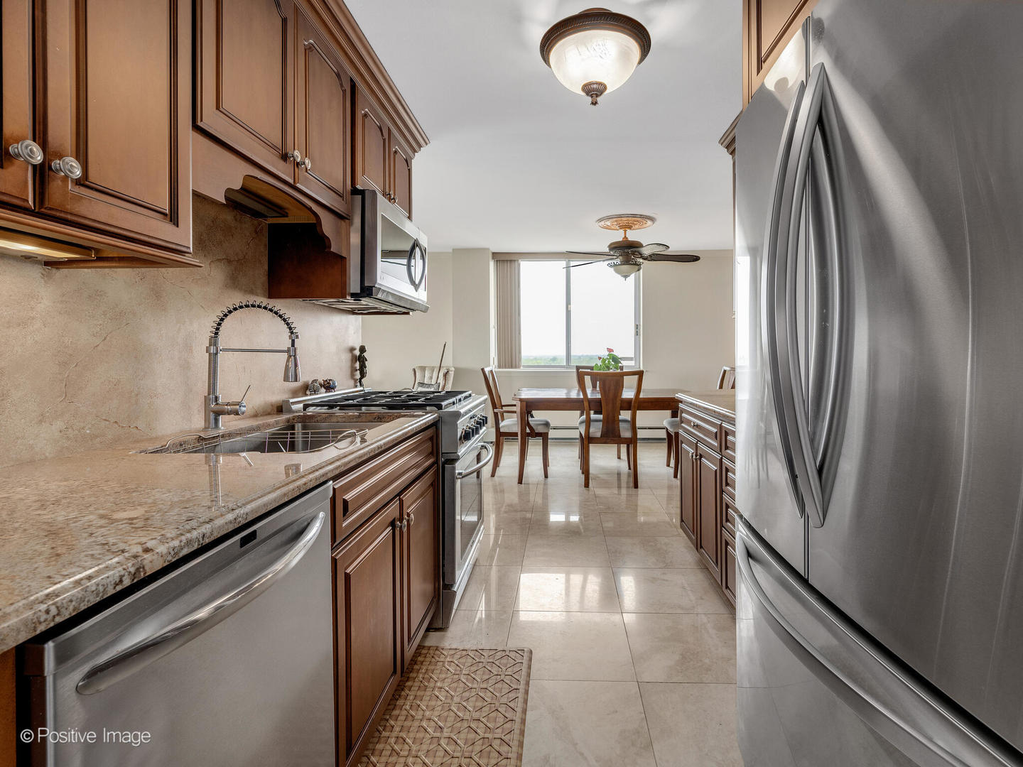 40 North Tower Road, Unit 12F Oak Brook, IL 60523 - Photo 12 of 25 a kitchen with stainless steel appliances granite countertop a sink a stove and a refrigerator