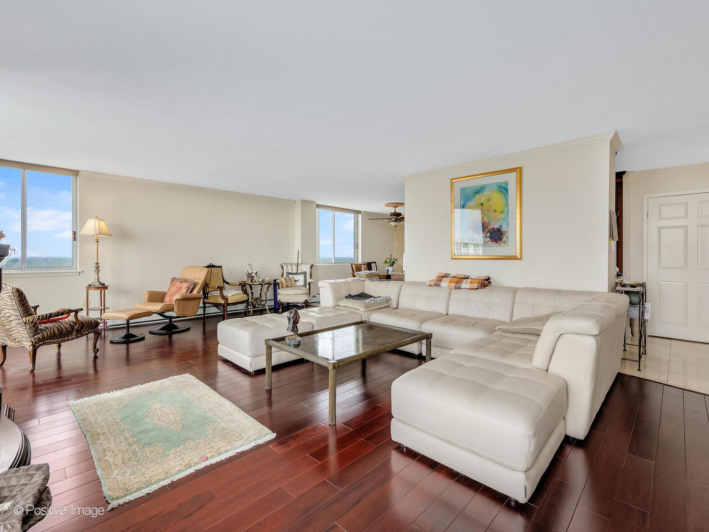 40 North Tower Road, Unit 12F Oak Brook, IL 60523 - Photo 4 of 25 a living room with couches and a dining table with wooden floor