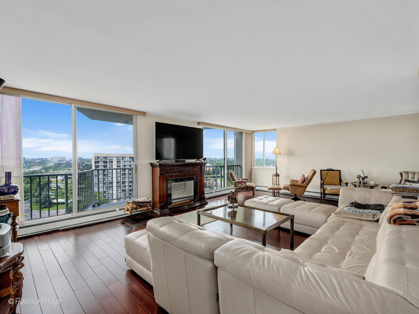 40 North Tower Road, Unit 12F Oak Brook, IL 60523 - Photo 5 of 25 a living room with fireplace furniture and a flat screen tv