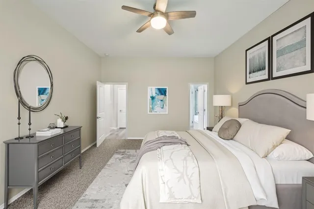 a bedroom with bed and a chandelier