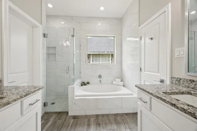 a bathroom with a granite countertop sink mirror and shower