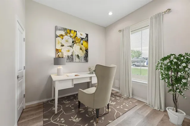 a view of a dining room with furniture window and wooden floor