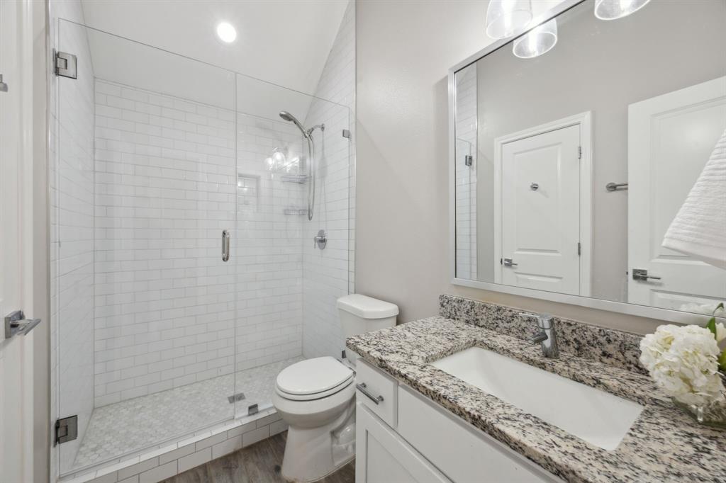 1122 Alicia Lane Lancaster, TX 75134 - Photo 16 of 37 a bathroom with a granite countertop sink toilet and shower
