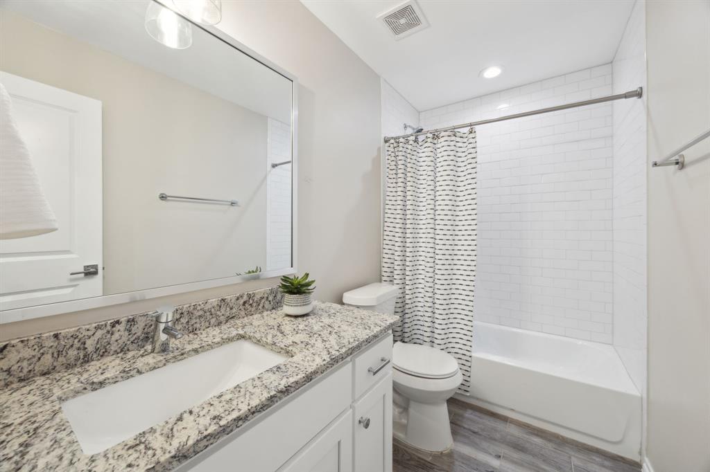 1122 Alicia Lane Lancaster, TX 75134 - Photo 18 of 37 a bathroom with a granite countertop sink a toilet and shower