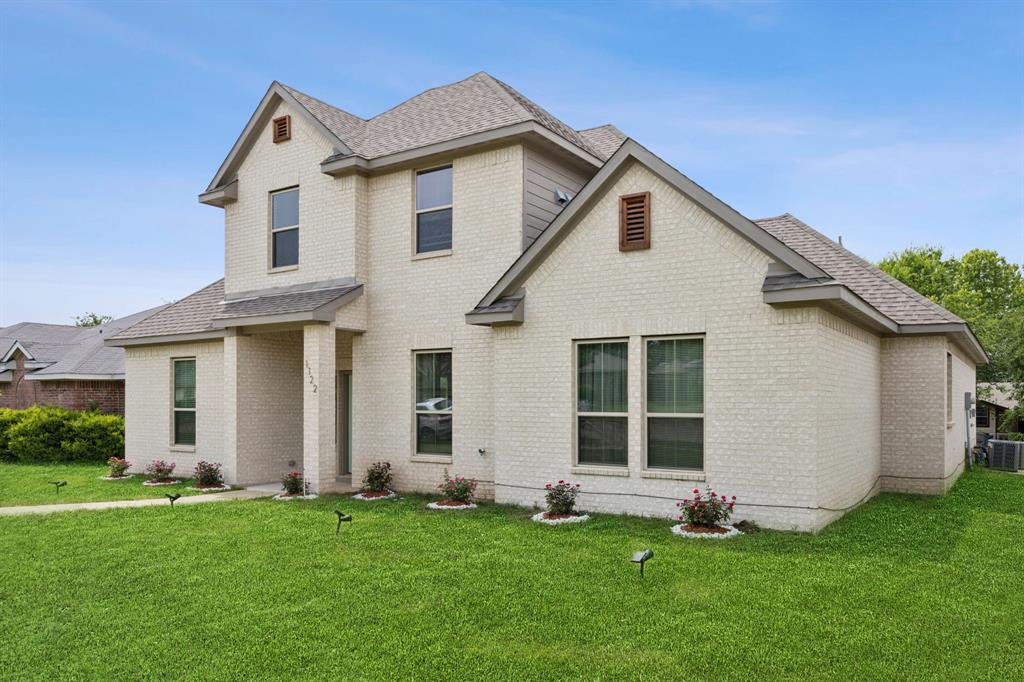 1122 Alicia Lane Lancaster, TX 75134 - Photo 27 of 37 a front view of a house with a yard