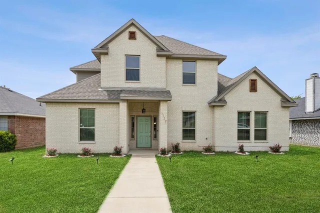 a front view of a house with a yard