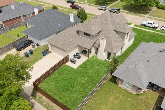 an aerial view of a house with a yard