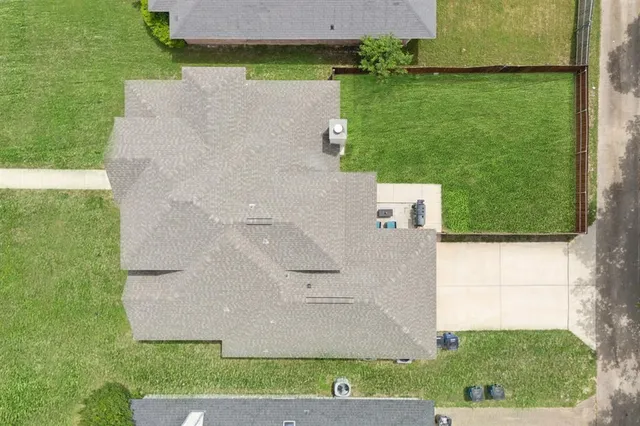 an aerial view of a house with a yard