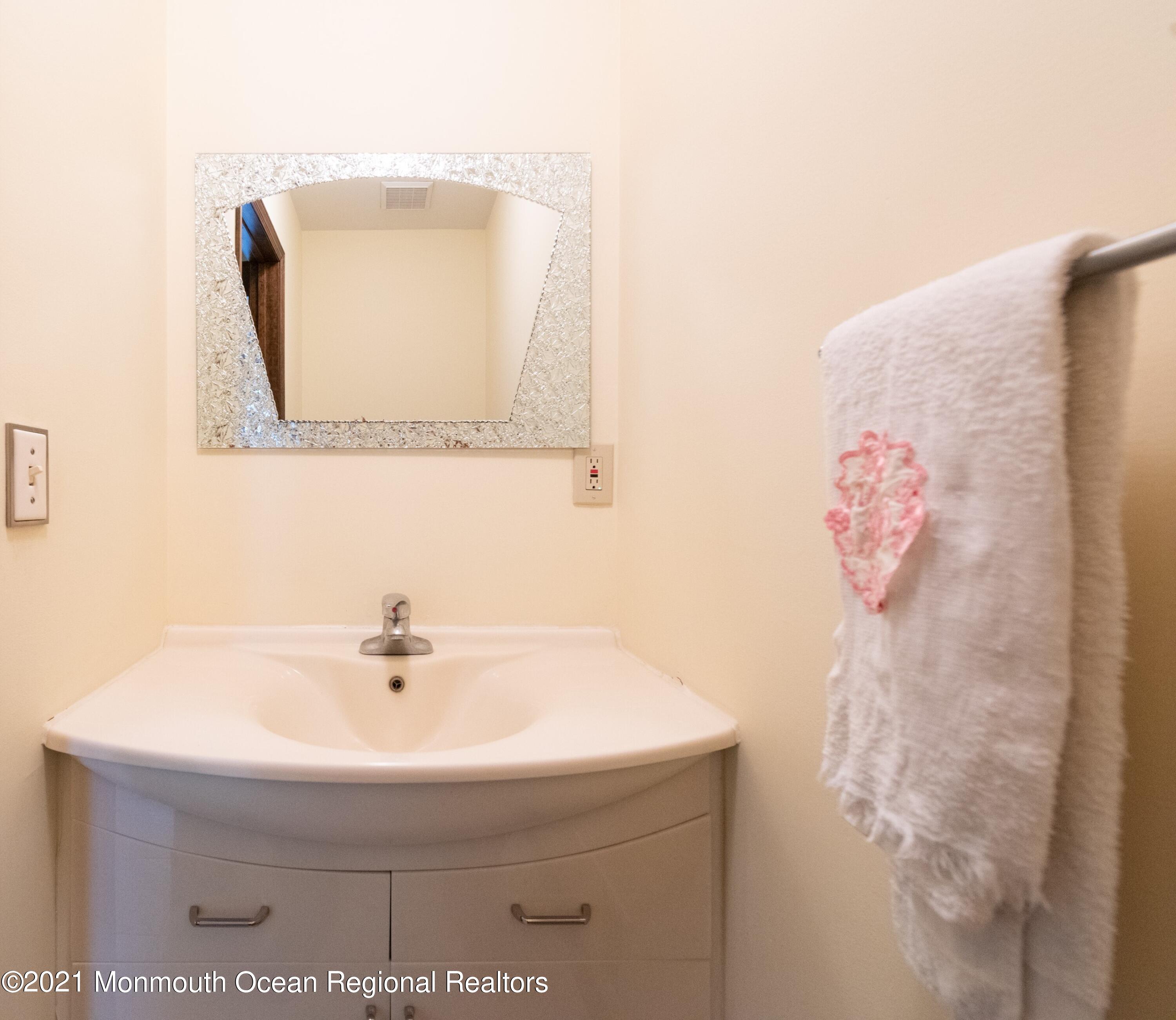 537 Line Road Aberdeen, NJ 07747 - Photo 15 of 23 a bathroom with a sink and a mirror