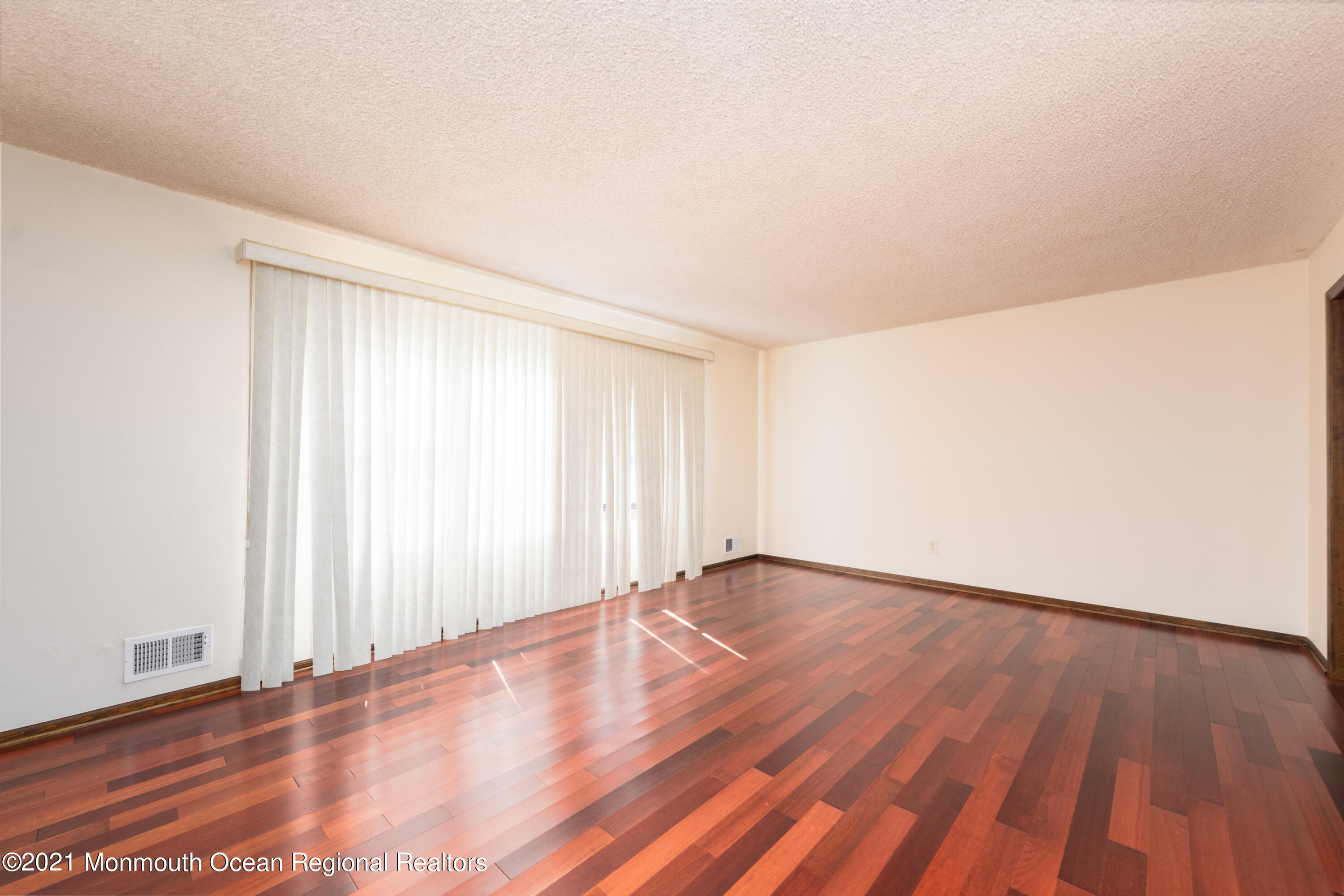 537 Line Road Aberdeen, NJ 07747 - Photo 4 of 23 a view of an empty room with wooden floor and a window