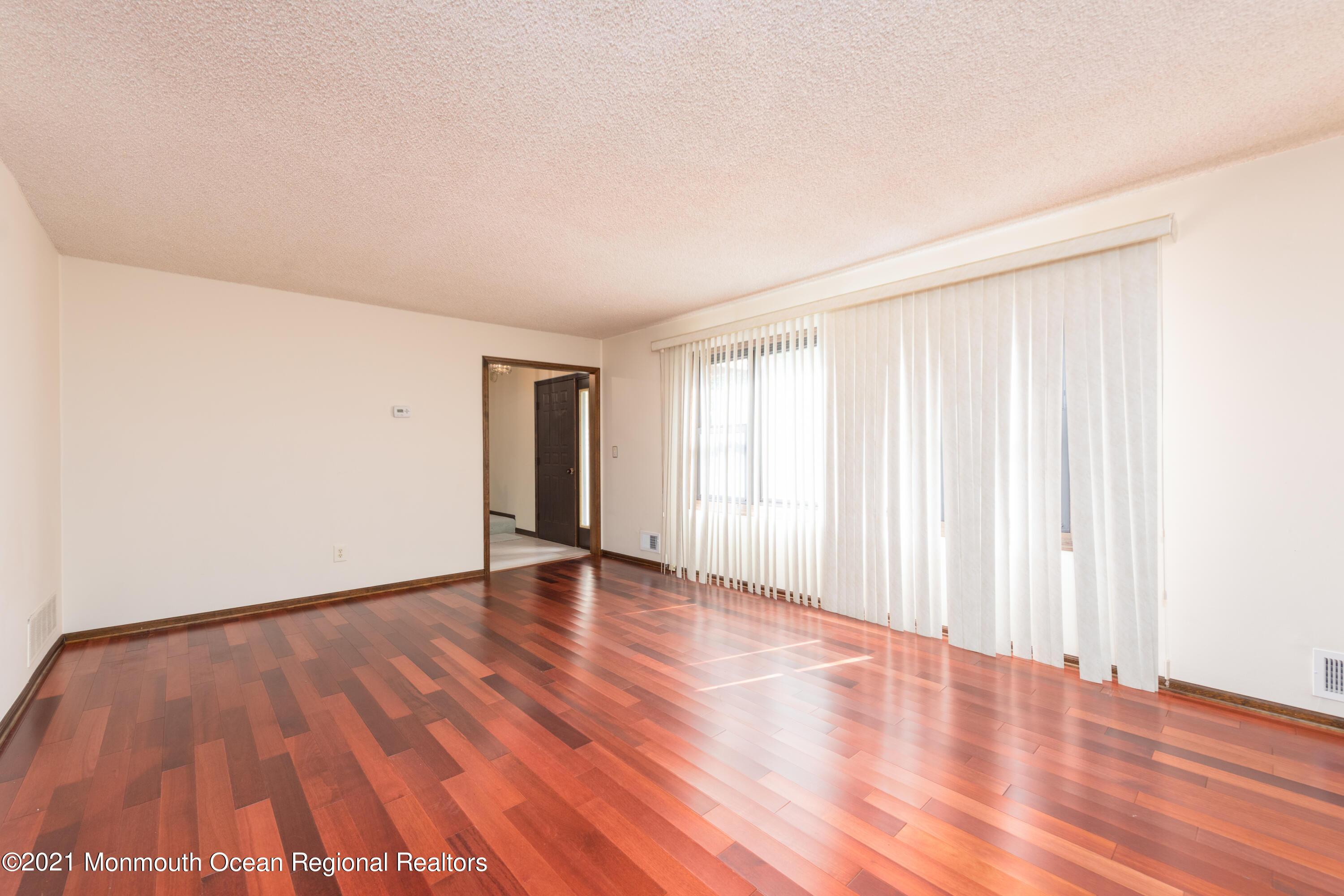 537 Line Road Aberdeen, NJ 07747 - Photo 5 of 23 a view of an empty room with wooden floor and a window