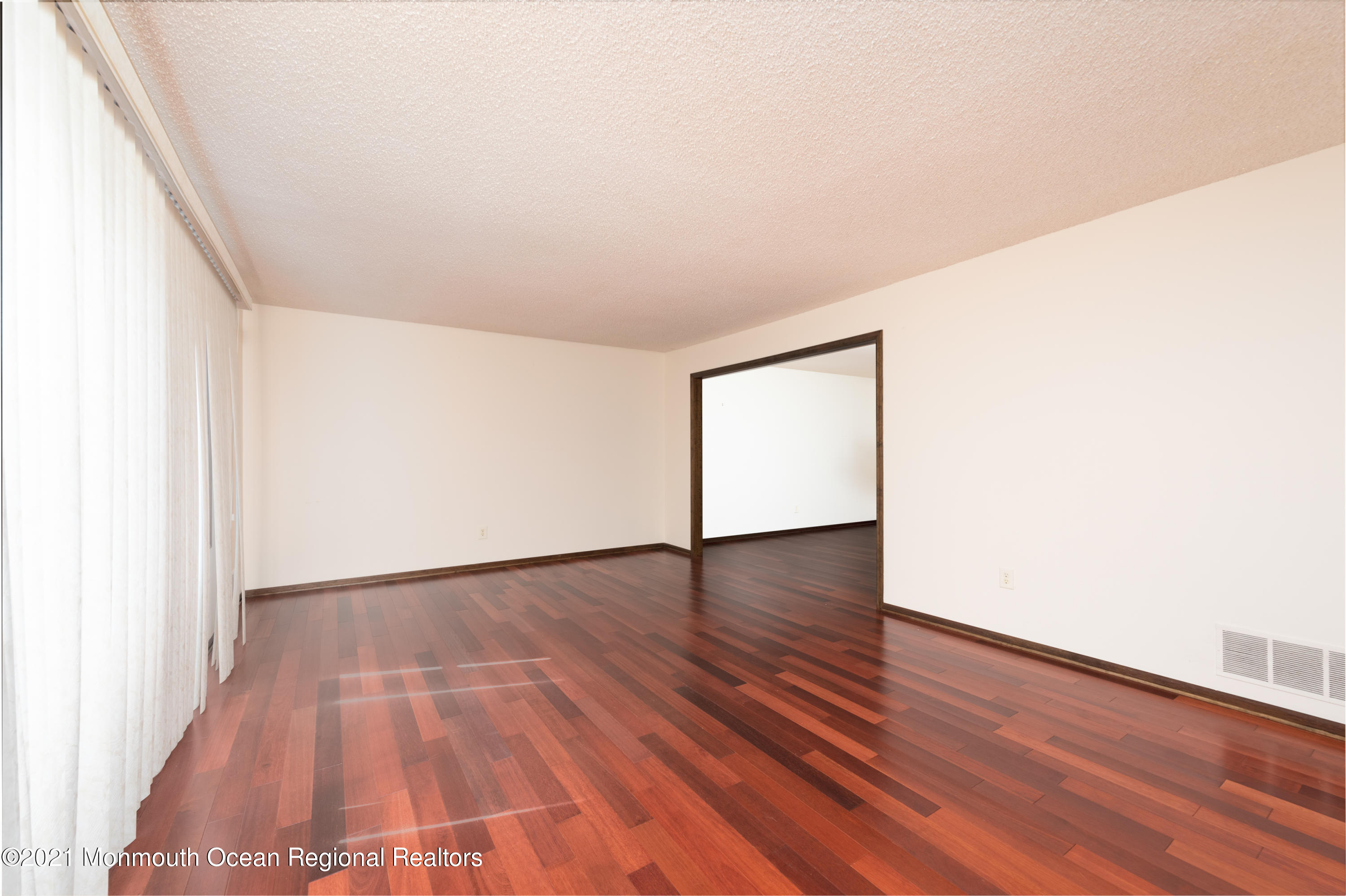 537 Line Road Aberdeen, NJ 07747 - Photo 6 of 23 a view of an empty room with wooden floor and a window