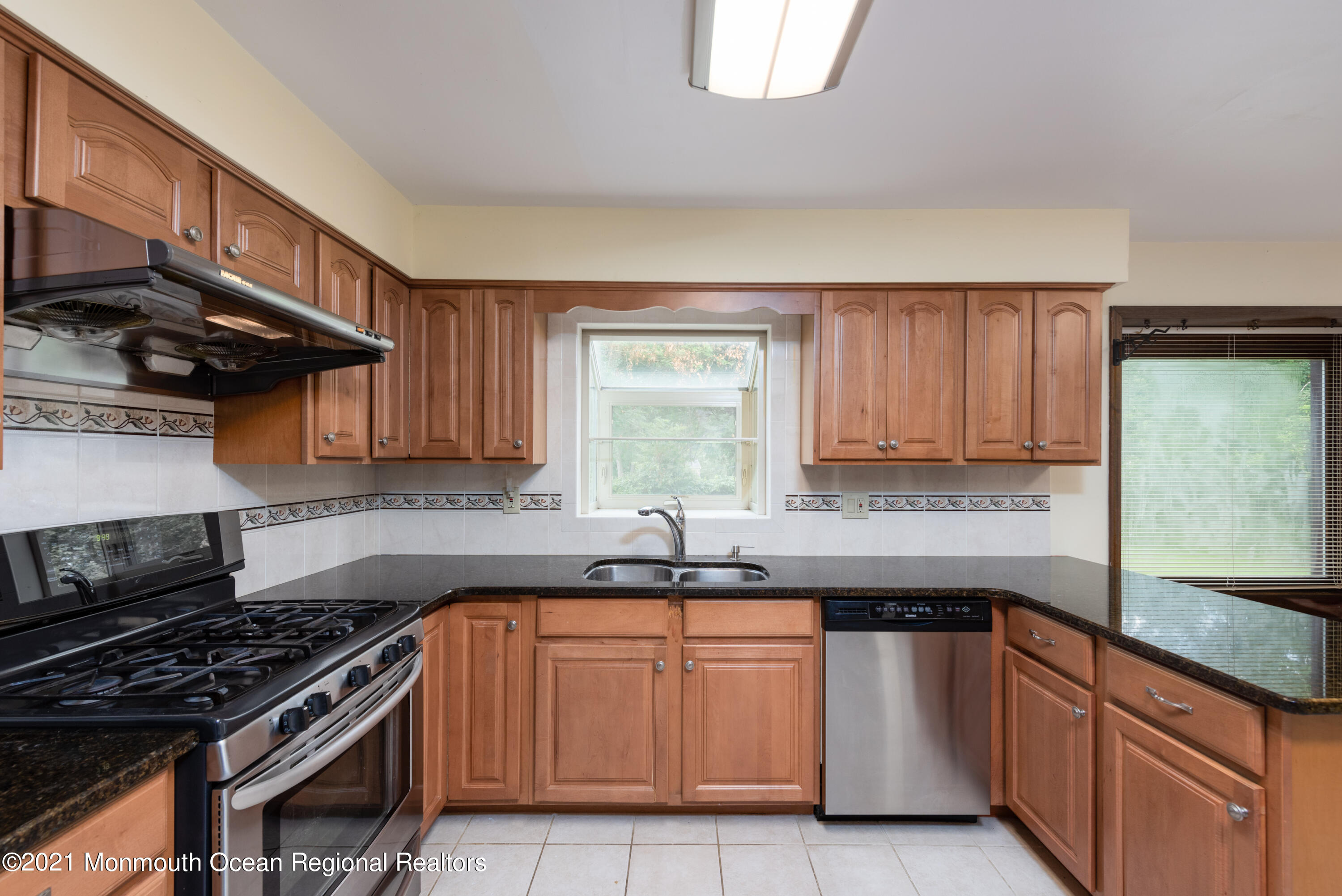 537 Line Road Aberdeen, NJ 07747 - Photo 8 of 23 a kitchen with granite countertop a sink a stove and cabinets