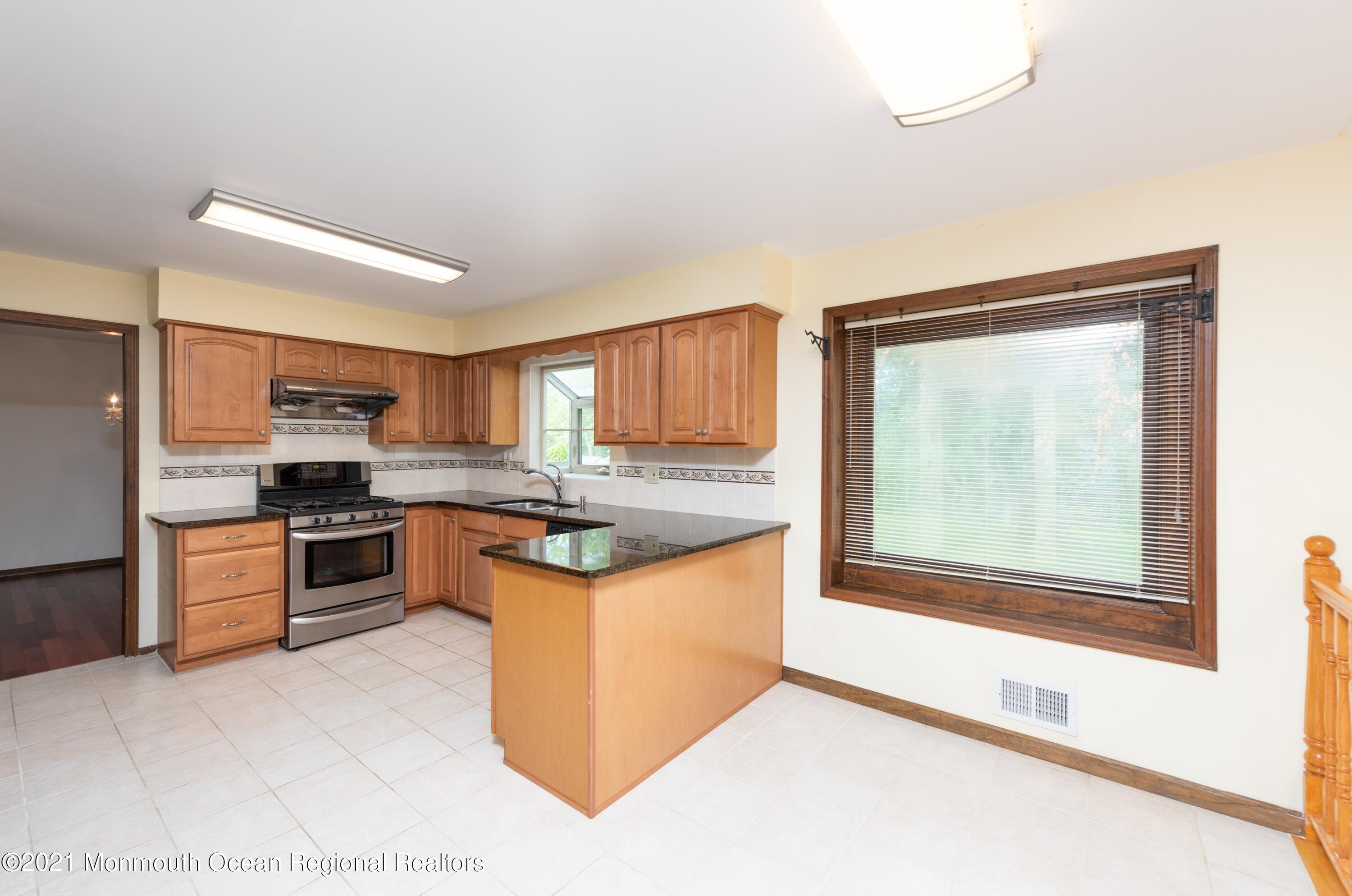 537 Line Road Aberdeen, NJ 07747 - Photo 9 of 23 a kitchen with stainless steel appliances granite countertop a stove a sink and a refrigerator