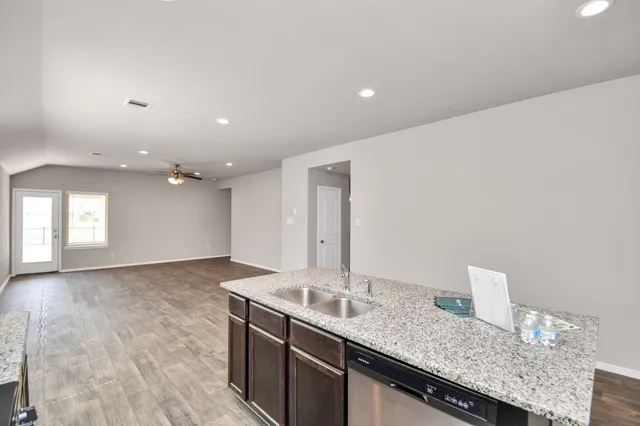 a bathroom with a granite countertop sink and a large mirror